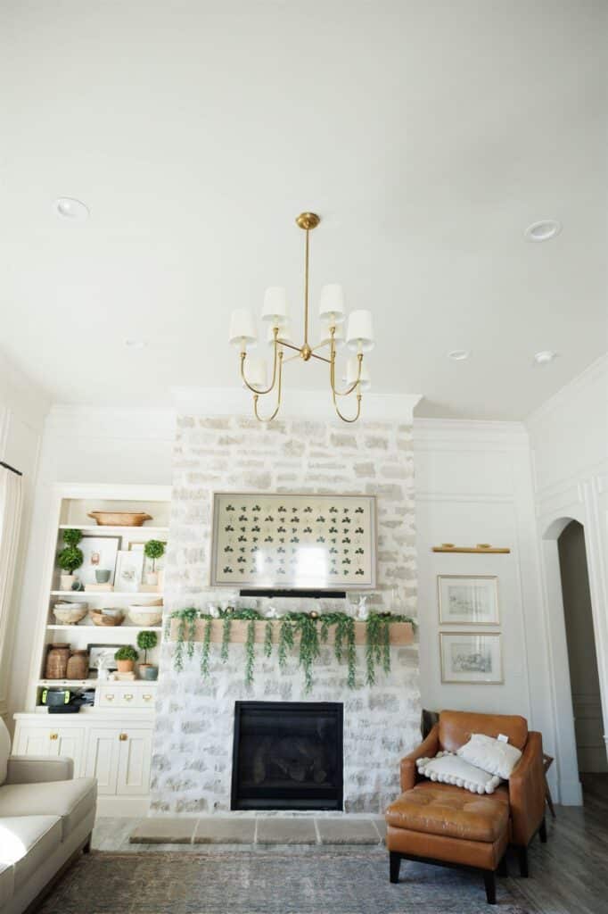 A cozy living room featuring a fireplace and a couch, showcasing elegant Crown Finish details.