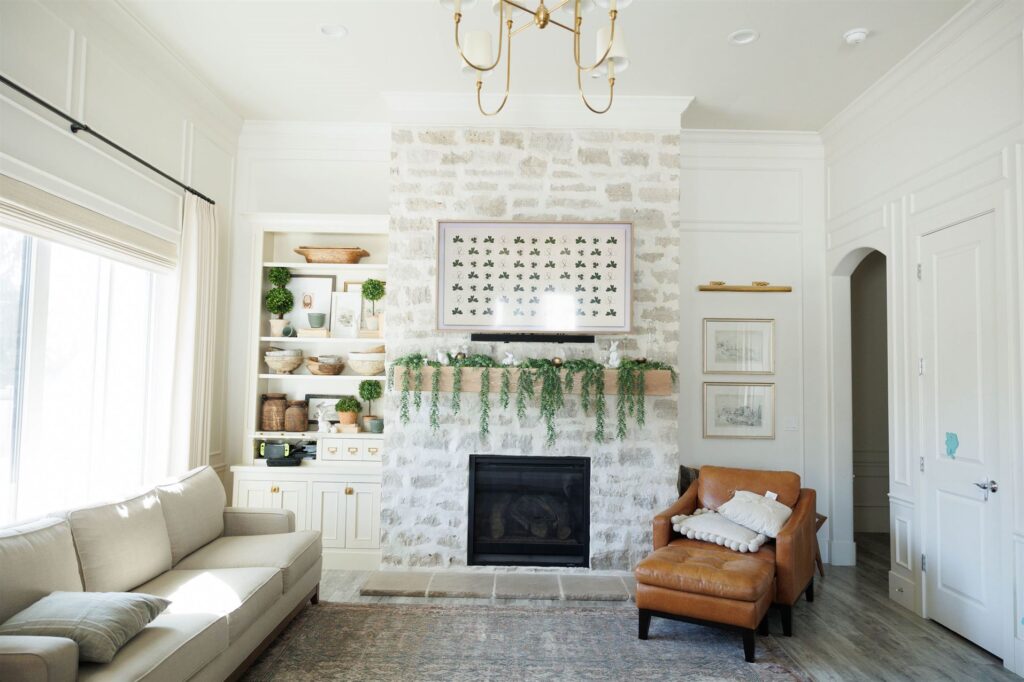 A cozy living room featuring a fireplace and a couch, showcasing elegant Crown Finish details.