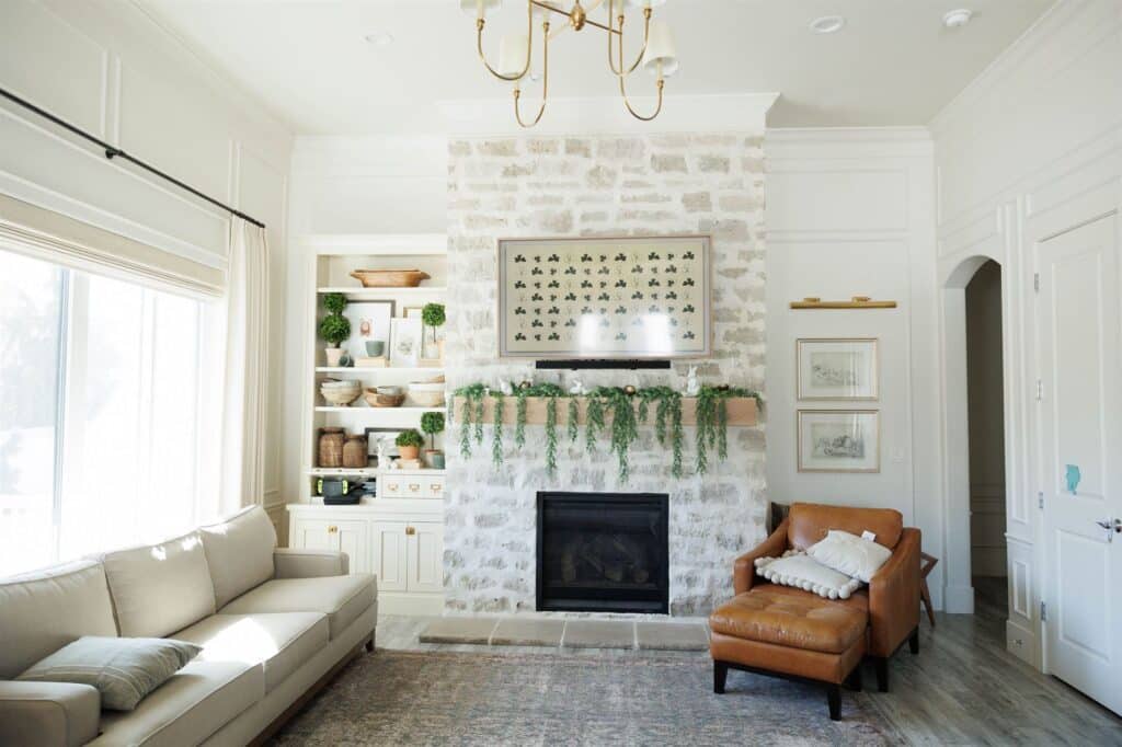 A cozy living room featuring a fireplace and a couch, showcasing elegant Crown Finish details.