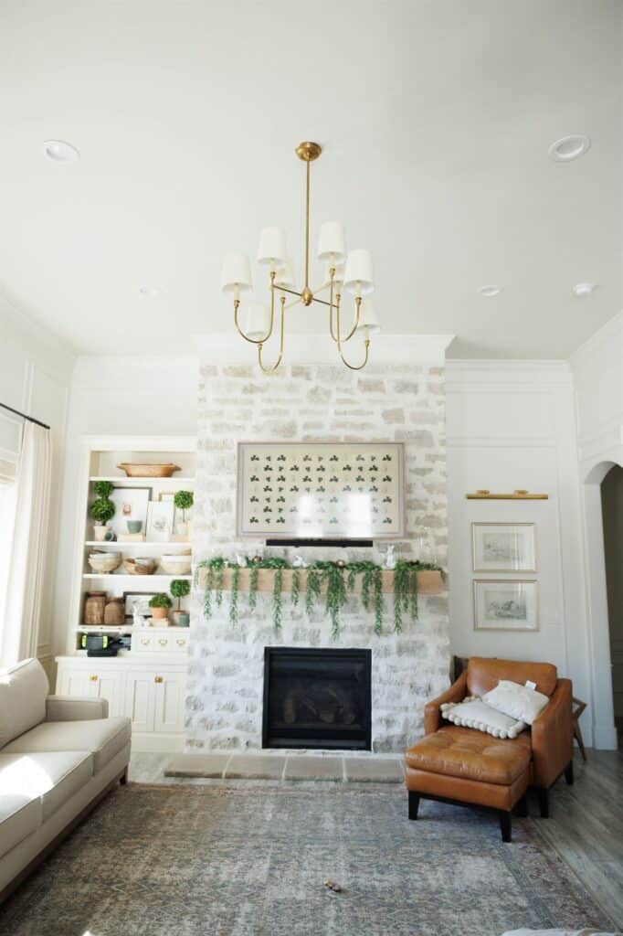 A cozy living room featuring a fireplace and a couch, showcasing elegant Crown Finish details.