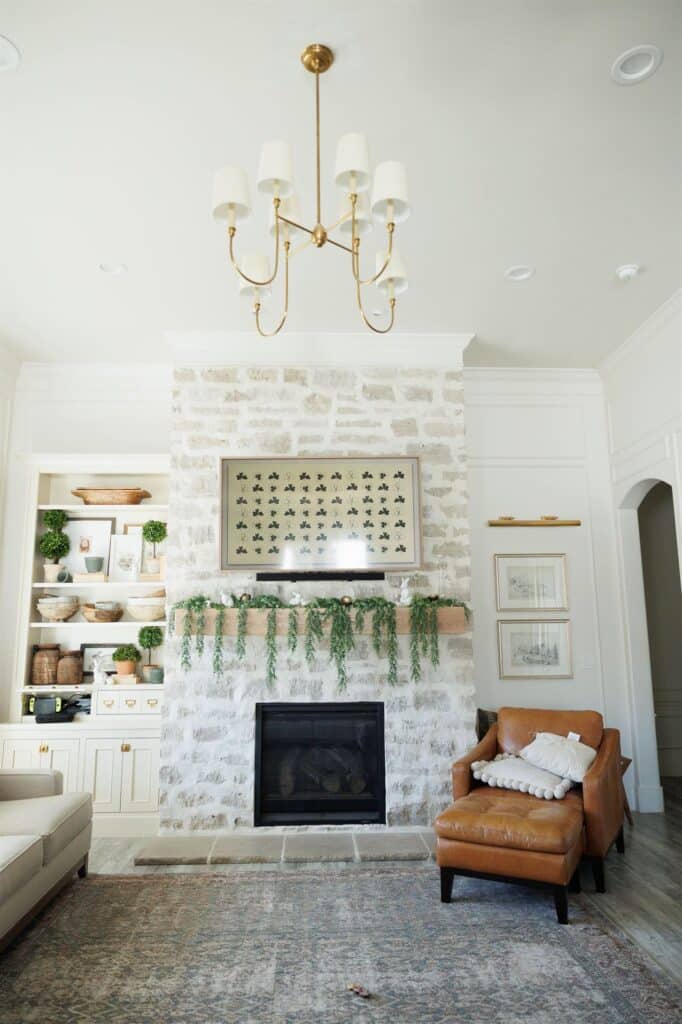 A cozy living room featuring a fireplace and a couch, showcasing elegant Crown Finish details.