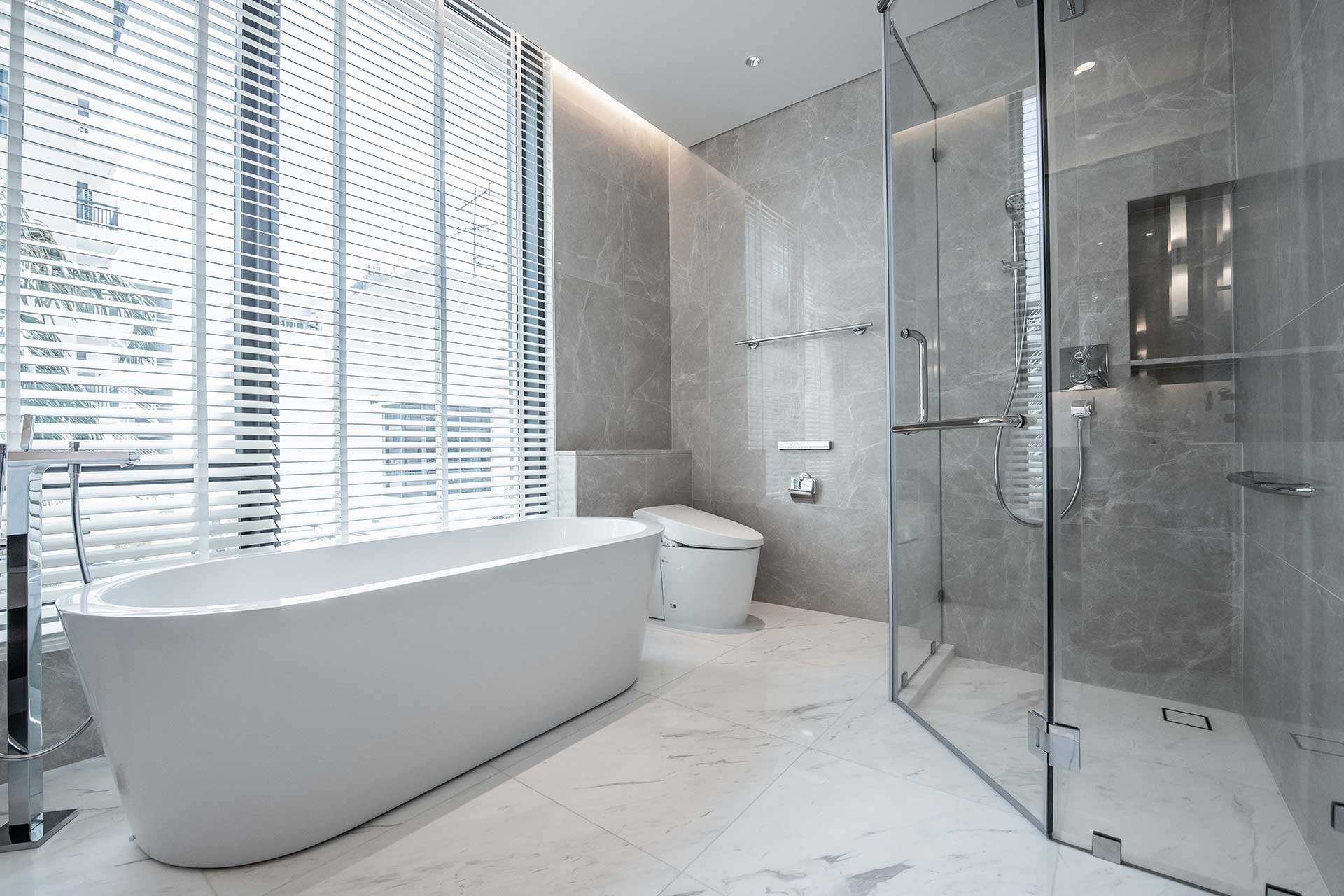 A spacious bathroom featuring a large tub and a walk-in shower, designed with elegant Crown Finish details.