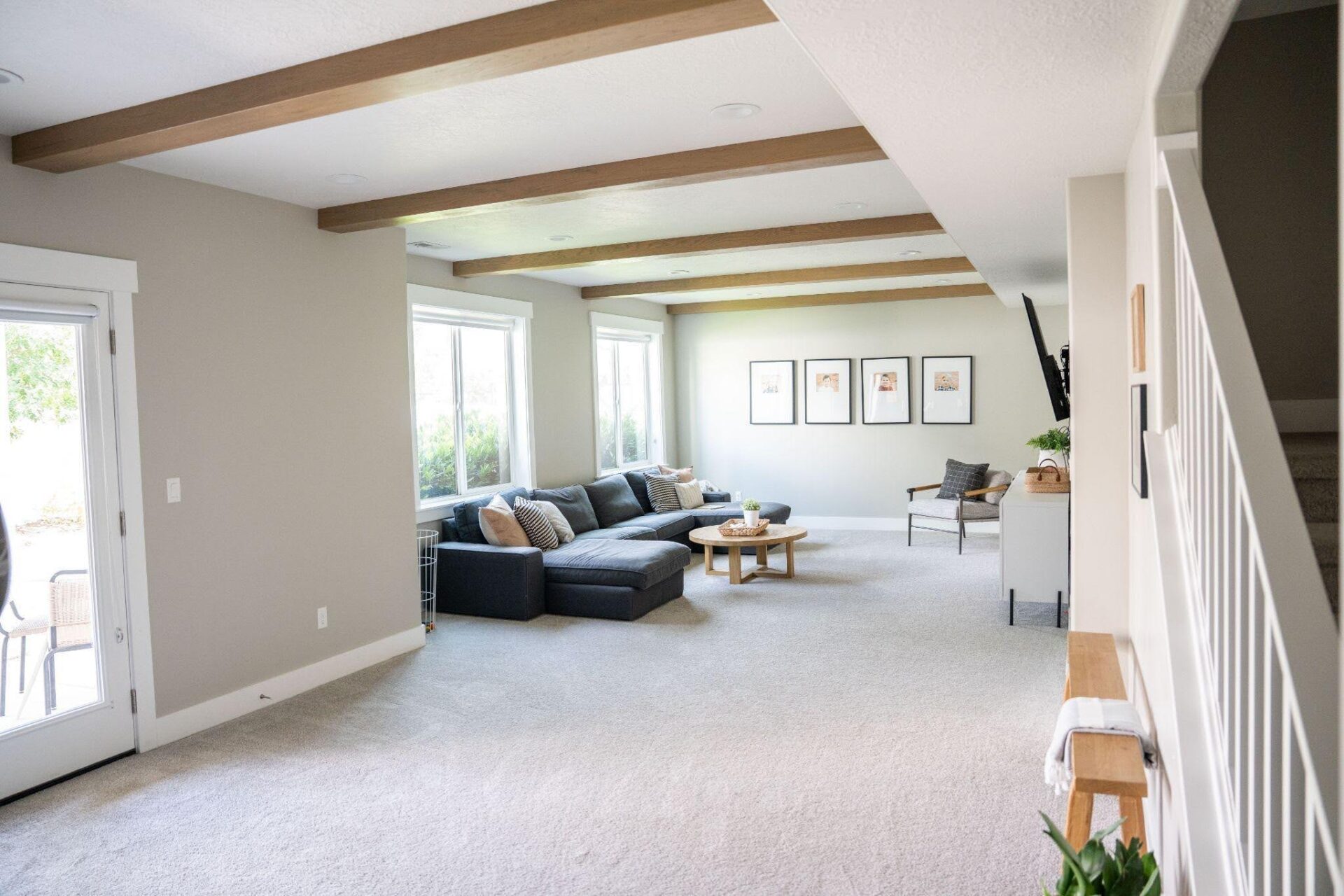A living room featuring a couch a coffee table and a staircase in the background