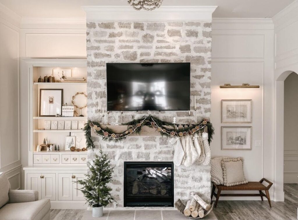 A white fireplace adorned with a festive Christmas wreath creating a warm holiday atmosphere