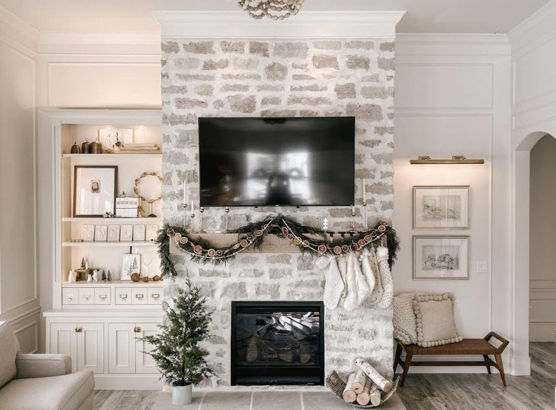 A white fireplace adorned with a festive Christmas wreath creating a warm holiday atmosphere